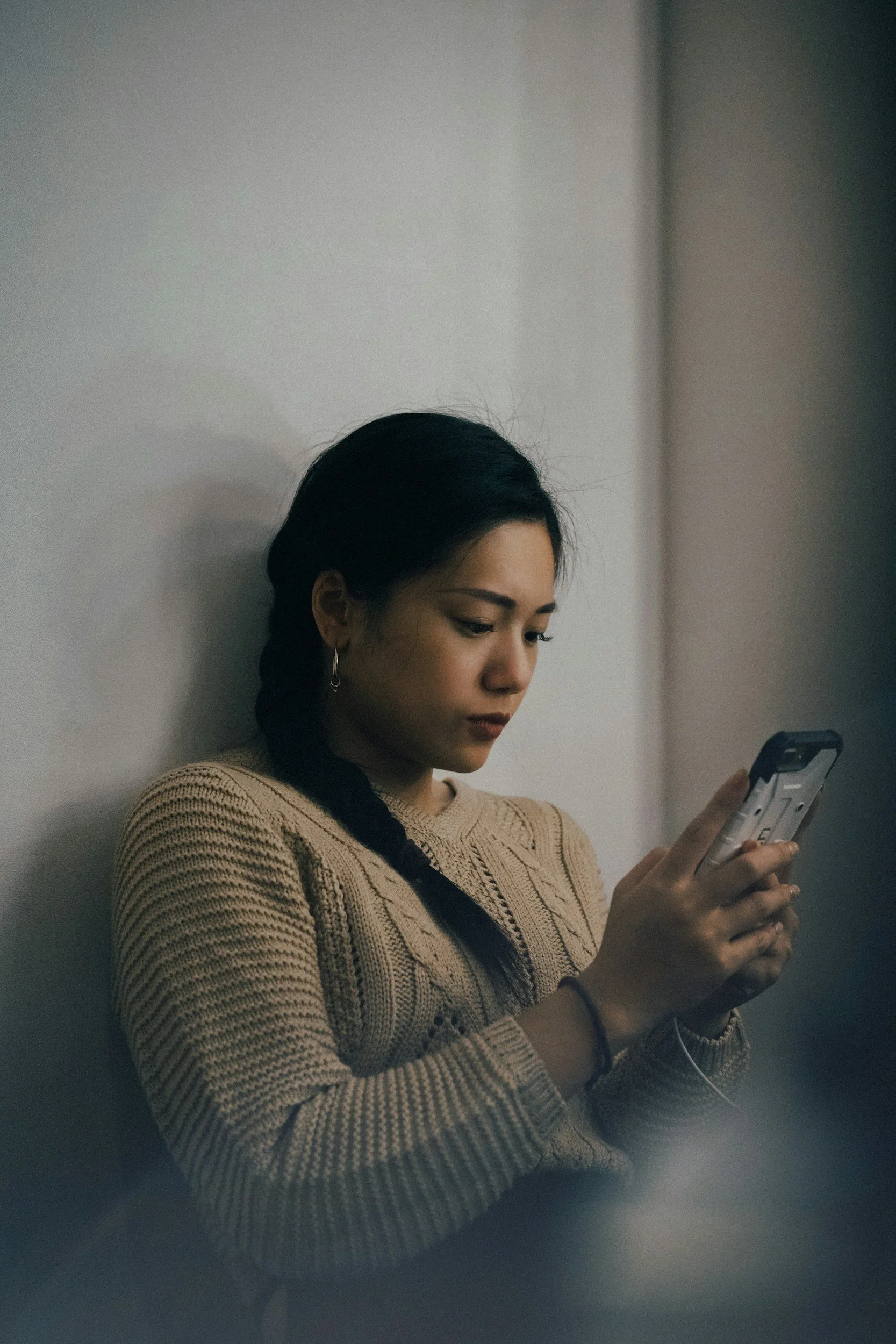 Woman Holding and Scrolling on her Phone