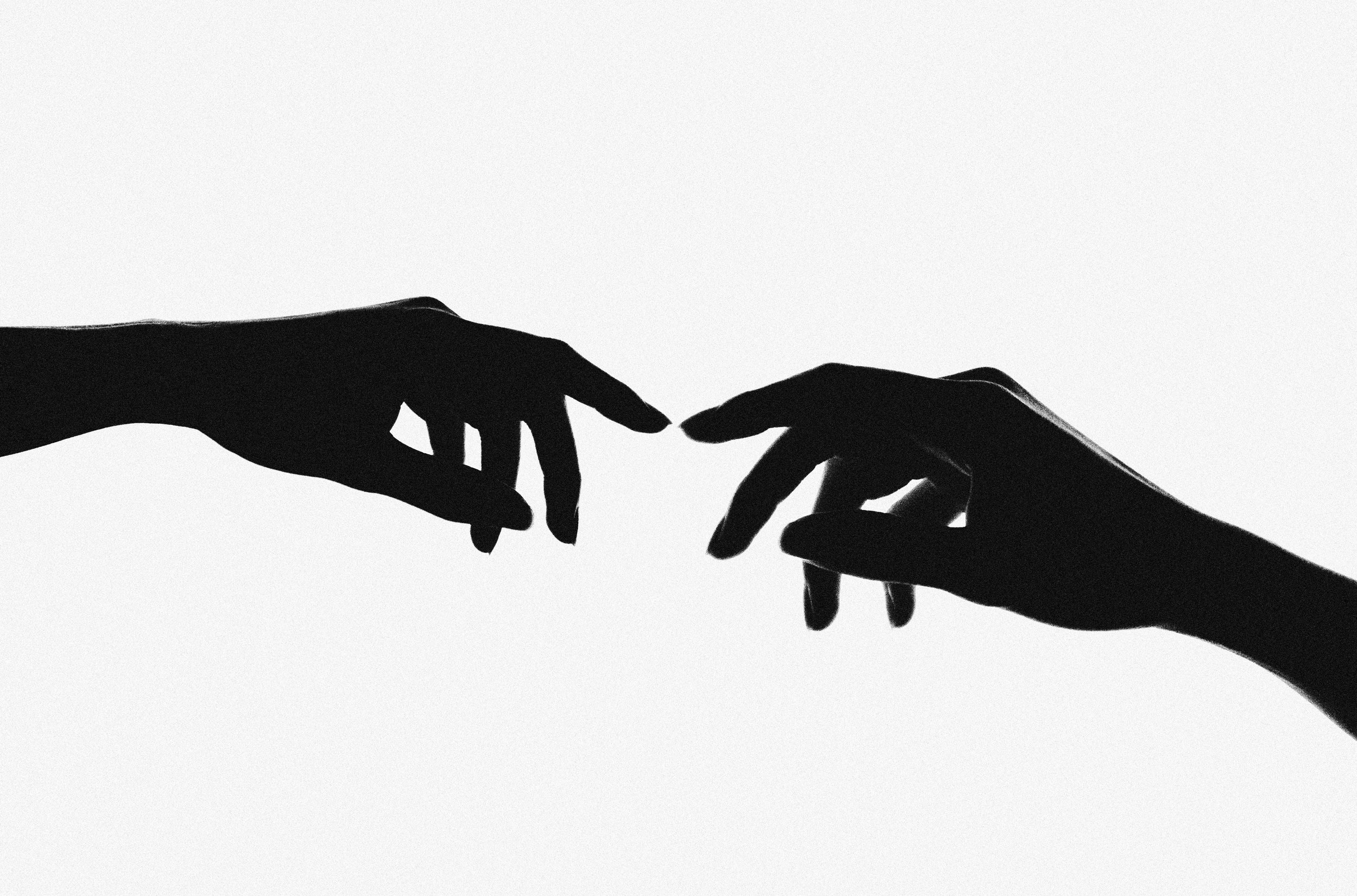 signs of attachment therapy in adults illustrated by two hands reaching out to one another